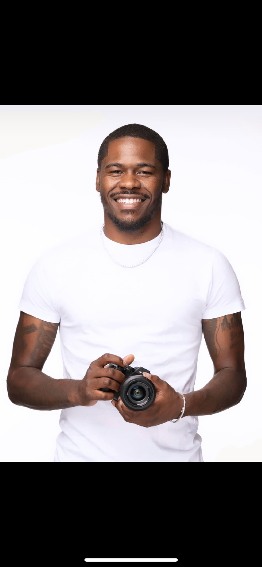 Bucktography — Houston photographer holding a professional camera